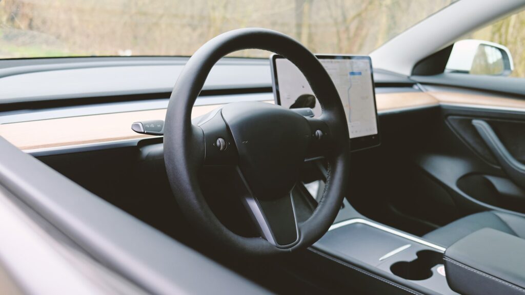 Interior dashboard with a modern interface design and steering wheel.